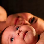 mum and baby who is teething lying together